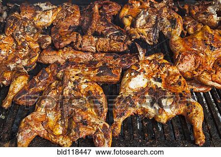 Chickens cooking on a barbeque grill View Large Photo Image Stock Photo - Chickens cooking on a barbeque grill. Fotosearch