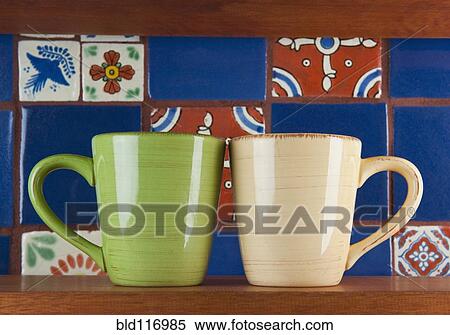 Stock Photography - Cups in Front of Colorful Tile. Fotosearch