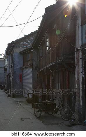 Picture - Delivery Tricycle in Alley. Fotosearch