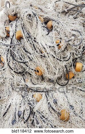 Stock Image - Detail of fishing nets piled up. Fotosearch