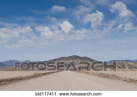 Stock Image - Dirt Road in the Desert. Fotosearch