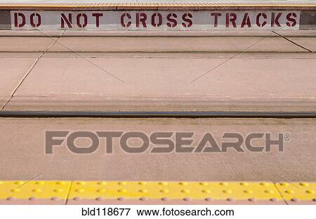 Do Not Cross Tracks sign at Light rail train station View Large Photo Image Stock Photo - Do Not Cross Tracks sign at Light rail train station. Fotosearch