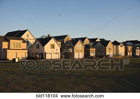Picture - Duplexes Near Grassy Field. Fotosearch