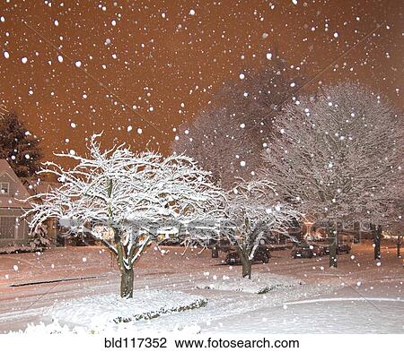 Stock Image - Falling Snow in a Neighborhood. Fotosearch