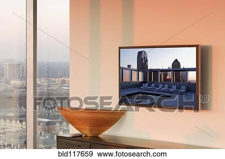 Stock Photo - Flat Screen TV on Wall at Sunset. Fotosearch