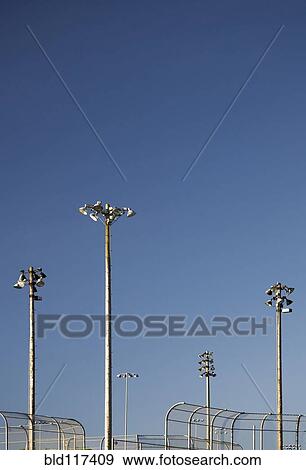 Floodlights Above Baseball Backstops View Large Photo Image Stock Photo - Floodlights Above Baseball Backstops. Fotosearch