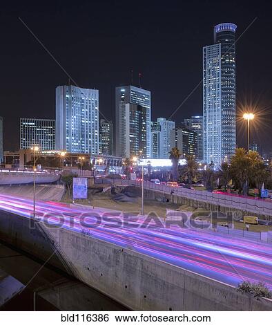 Stock Photograph - Freeway Passing Downtown Buildings At Night. Fotosearch