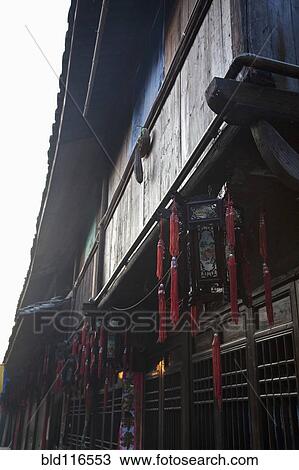 Stock Image - Hanging Red Decorations on Building. Fotosearch