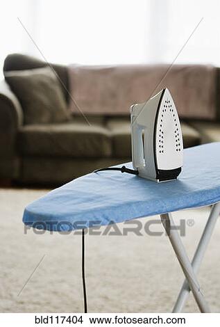 Iron on an Ironing Board View Large Photo Image Picture - Iron on an Ironing Board. Fotosearch