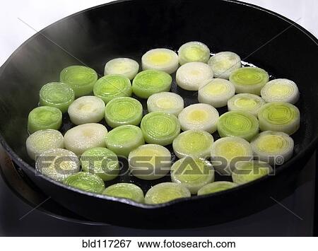 Leeks Cooking in Cast Iron Skillet View Large Photo Image Stock Photo - Leeks Cooking in Cast Iron Skillet. Fotosearch
