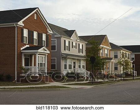 Stock Image - Neighborhood Homes On Street Corner. Fotosearch