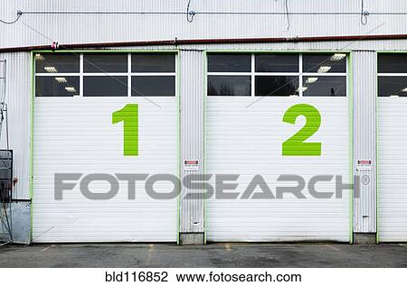 Stock Image - Numbers On Repair Shop Bay Doors. Fotosearch