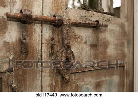 Stock Photo - Old Iron Door Latch on Wooden Door. Fotosearch