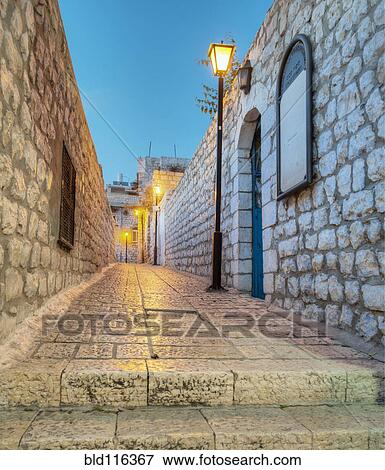 Stock Photo - Old Stone Alleyway With Electric Lights. Fotosearch