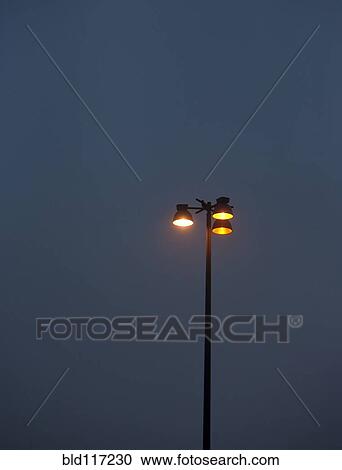 Stock Image - Parking Lot Lights at Dusk. Fotosearch