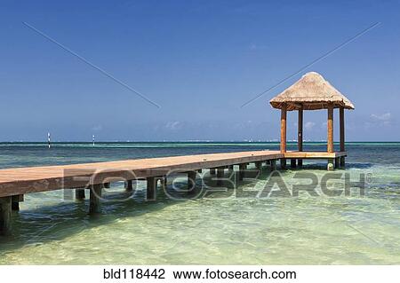 Pier over turquoise blue water on the beach at Cancun View Large Photo Image Stock Image - Pier over turquoise blue water on the beach at Cancun. Fotosearch