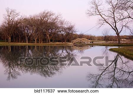 Stock Photo - Pond with Trees and Foot Bridge. Fotosearch