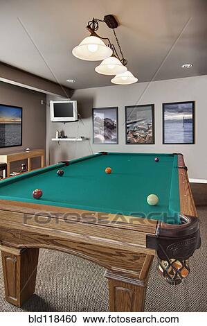 Pool table in basement with double doors and a large window View Large Photo Image Stock Image - Pool table in basement with double doors and a large window. Fotosearch