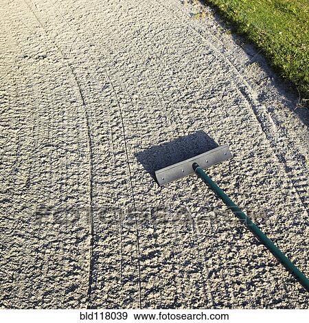 Stock Photo - Rake in a Sand Trap. Fotosearch