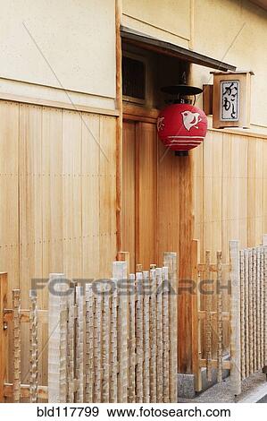 Stock Photo - Red Asian Lamp Hanging Outside a Building Door. Fotosearch