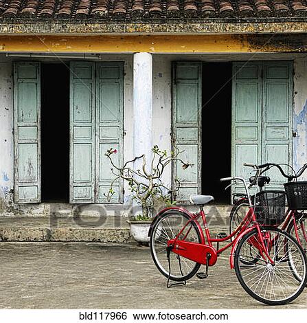 Red Bikes Parked in Front of a Weathered Building View Large Photo Image Stock Photograph - Red Bikes Parked in Front of a Weathered Building. Fotosearch