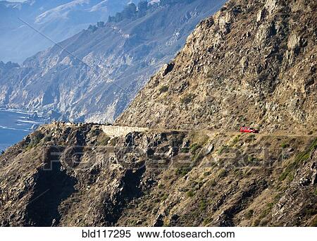 Red Car on Coastal Mountain Road View Large Photo Image Stock Photography - Red Car on Coastal Mountain Road. Fotosearch