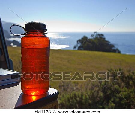Red Water Bottle with Ocean in Background View Large Photo Image Stock Photo - Red Water Bottle with Ocean in Background. Fotosearch