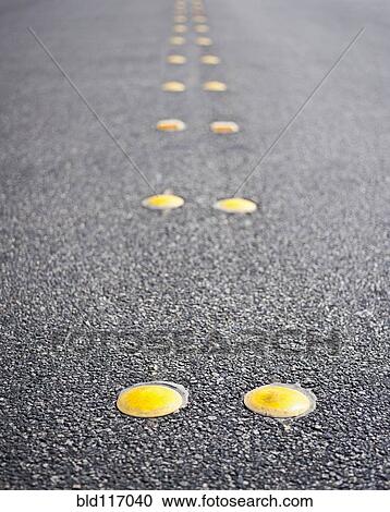 Stock Image - Reflective Roadway Divider Bumps. Fotosearch