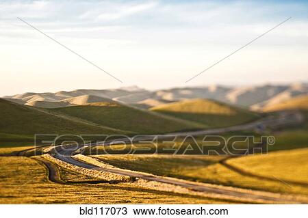 Stock Image - Road in Rolling Hills. Fotosearch