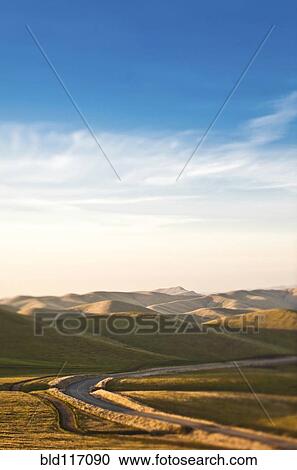 Stock Image - Road in Rolling Hills. Fotosearch