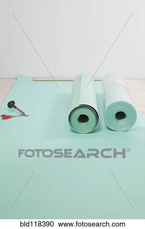 Rolls of underlay, or sub-flooring material, and a partly installed laminate floor View Large Photo Image Stock Image - Rolls of underlay, or sub-flooring material, and a partly installed laminate floor. Fotosearch
