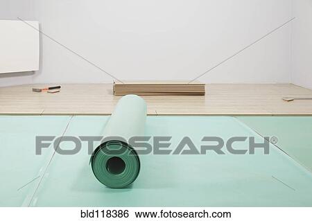 Rolls of underlay, or sub-flooring material, and a partly installed laminate floor View Large Photo Image Stock Photograph - Rolls of underlay, or sub-flooring material, and a partly installed laminate floor. Fotosearch