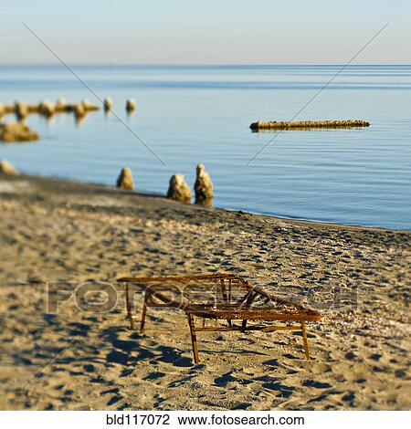 Stock Image - Rusty Bed on Beach. Fotosearch