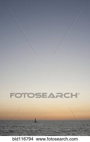 Sailboat at Sunset View Large Photo Image Picture - Sailboat at Sunset. Fotosearch
