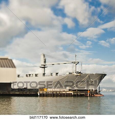 Stock Image - Ship and Loading Dock at a Seaport. Fotosearch
