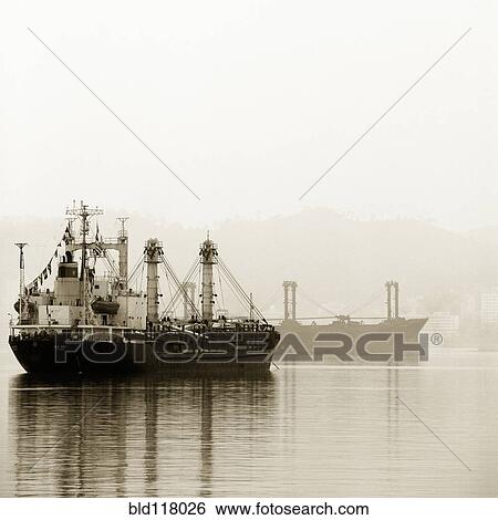 Stock Photograph - Shipping Boats in the Mist. Fotosearch