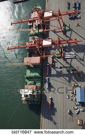 Stock Photo - Shipping Containers To Be Loaded Onto Semi Trucks. Fotosearch