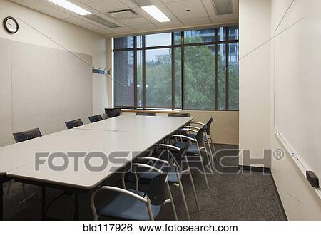 Stock Photograph - Small empty boardroom, with a long rectangular table and chairs. Fotosearch