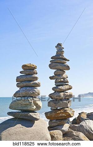 Small tapering pillars of rocks placed one on top of the other View Large Photo Image Stock Photography - Small tapering pillars of rocks placed one on top of the other. Fotosearch