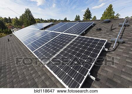 Solar panels fixed on the rooftop of a house View Large Photo Image Stock Photo - Solar panels fixed on the rooftop of a house . Fotosearch