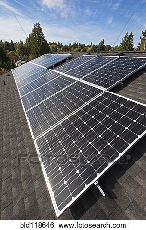 Solar panels fixed on the rooftop of a house View Large Photo Image Stock Photograph - Solar panels fixed on the rooftop of a house . Fotosearch