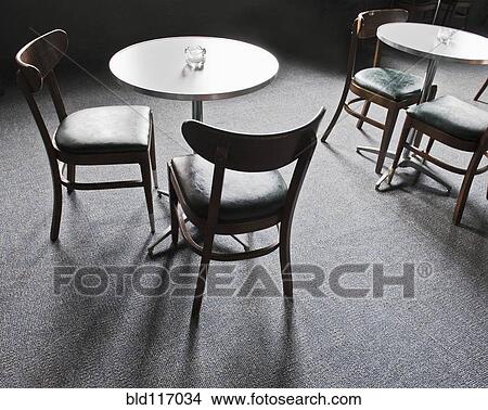 Tables and Chairs in a Cafe View Large Photo Image Picture - Tables and Chairs in a Cafe. Fotosearch