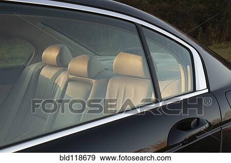 The leather backseat of a car viewed through side window View Large Photo Image Stock Photo - The leather backseat of a car viewed through side window. Fotosearch
