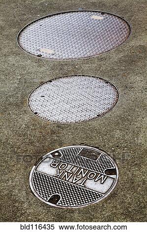 Three manhole covers on street View Large Photo Image Stock Photography - Three manhole covers on street. Fotosearch