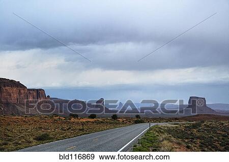 Stock Photo - Two Lane Road Passing Through Desert. Fotosearch