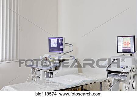 Picture - Ultrasound test computer equipment, a computer monitor screen, and a treatment bed. Fotosearch