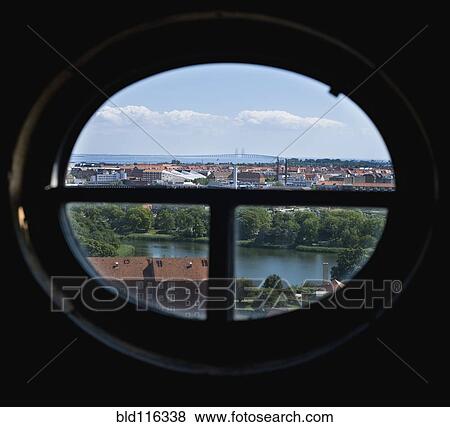 Stock Photo - View of town through oval window. Fotosearch