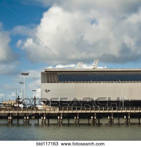 Stock Image - Warehouse and Cranes At a Seaport. Fotosearch