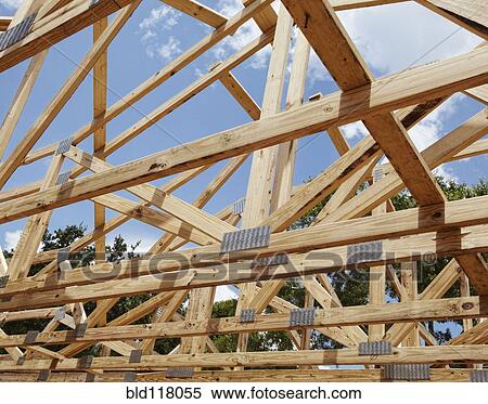 Stock Photography - Wooden Beams Across an Unfinished Home. Fotosearch