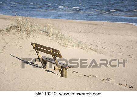 Stock Image - Wooden Bench on the Beach. Fotosearch